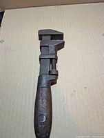 Full view of wrench front side showing jaws, screw and wooden handle