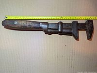 Full left-side view of 18" adjustable monkey wrench with tape for scale