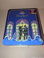 Closed blue Crown Royal collector tin lid showing winter graphic