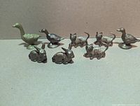 All eight gold plastic animal figures arranged together