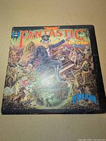 Front cover fantasy artwork with album title and Elton John name