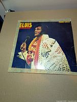 Front album jacket with image of Elvis Presley, wear and masking tape visible