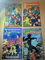 Front covers of The Strangers issues 2, 3, 5, 6 in protective bags and boards