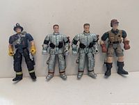 Front view of all four figures standing upright