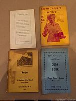 Front covers of all four cookbooks displayed