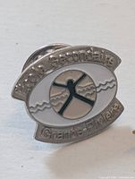 Silver-tone École secondaire Grande-Rivière enamel pin close-up