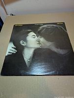 Front jacket showing Lennon and Ono kiss