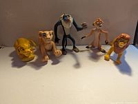 Five figures: young Simba crawling, Nala, Rafiki, Timon, Mufasa