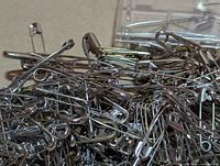 Close-up of loose stainless steel safety pins