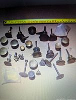 Group view of all brass pulls with measuring tape for scale