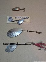 Front view of four lures including Worth spinner on card