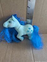 Bowtie pony left side view showing blue bow tie symbols and blue mane