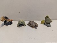 Front view of four Wade Whimsies figurines: trout, frog, turtle, angelfish
