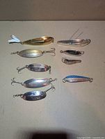 Top view of all nine spoon lures arranged in two columns