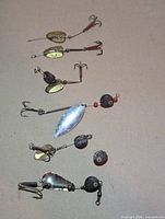 Six lures laid out showing overall design and condition