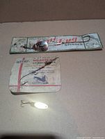 Front view of three lures, two on cards one loose