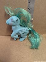 Medley Pegasus pony left side view with teal mane and musical note symbol