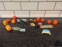 Full lot view with all toys, puzzle pieces and plastic capsules