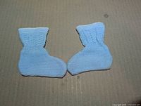 Both socks front view, showing light blue knit and cuff detail