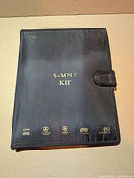 closed binder front showing SAMPLE KIT text