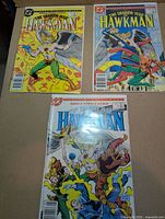 All three comics laid out: #2 yellow cover, #3 blue cover, #4 white cover