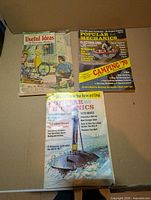 Front covers of the three magazines showing titles and cover art