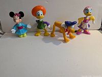 Minnie Mouse kimono, Donald green shirt, Pluto blue cap, Daisy purple dress