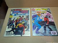 Both bagged comic books side by side