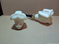 Front view showing both milk glass pipe decanters, cowboy hat detail visible