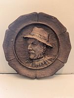 Front view of plaque showing elderly man portrait