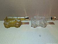 Amber and clear Old Spice cannon bottles side by side