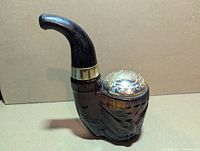 Full view of pipe-shaped brown glass decanter with cap