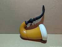 Left side view showing yellow bowl, white rim, black stem