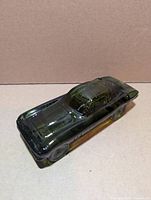 Top and side view of green glass Corvette bottle showing overall shape and color