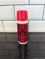 Front view showing plaid pattern and Thermos 15 label