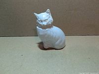Front view of white milk glass cat perfume bottle showing overall form