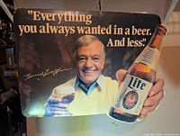 Front view of cardboard sign showing slogan, Geoffrion portrait and Lite bottle