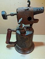 Left side view showing brass body, burner head, wood handle