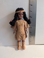 Front view of doll showing outfit, beadwork, height reference
