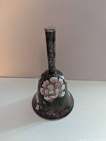 Front view of cloisonné hand bell showing floral enamel design