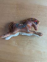 Full view of satin embroidered horse figure