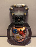 Front view showing painted flowers on copper bell and integrated opener