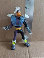 Front view of Duke L'Orange figure showing armor, suit detail, ruler for scale