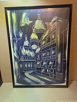 Full view of framed blue and white Paris street scene print in black frame