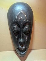 Full view of wooden mask showing overall design and inlay
