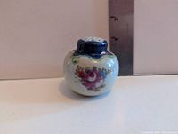 Front view showing floral motif and cobalt top