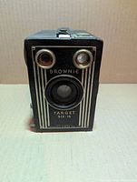 Front view showing lens, twin viewfinders, Brownie Target Six-16 nameplate