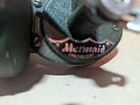 Close-up of Mermaid Canadian Tire Corp logo on reel body