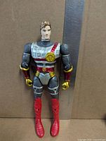 Front view of Rohan action figure beside ruler showing height