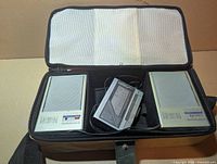 Open carrying case displaying Sanyo player between two Citizen speakers